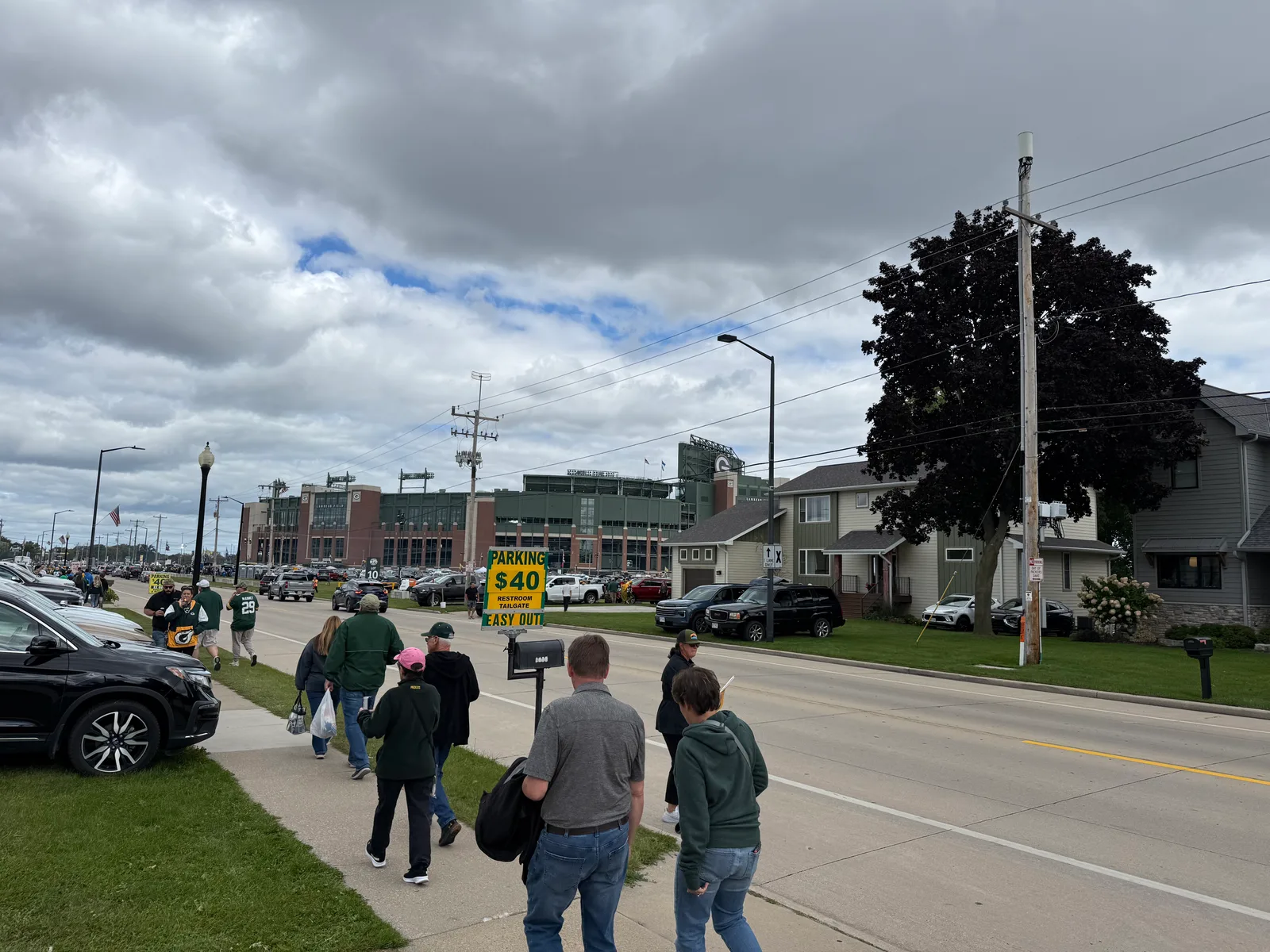 Fans walking from a yard parking spot to Lambeau Field