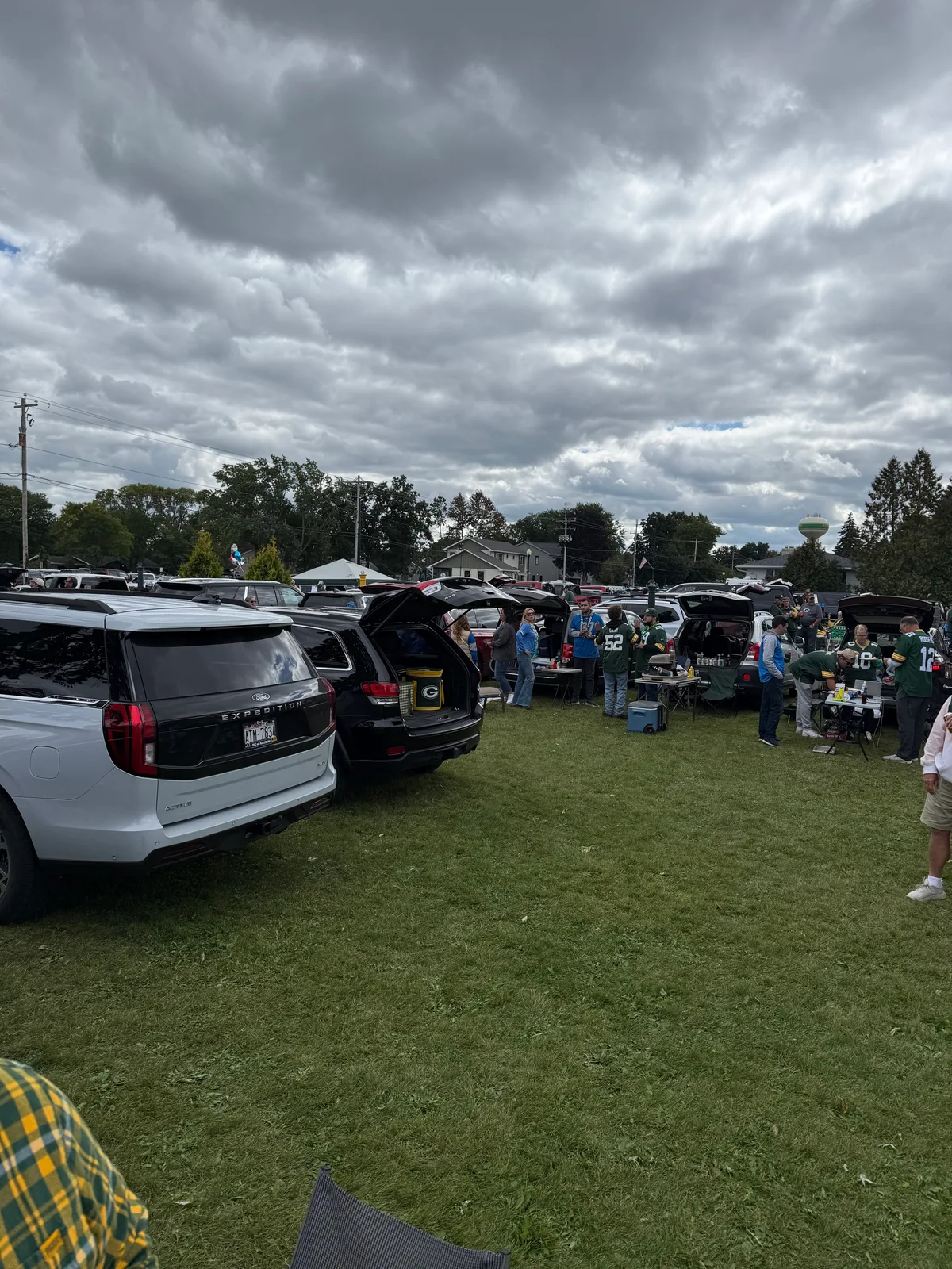 Cars parked in a yard near Lambeau Field on game day